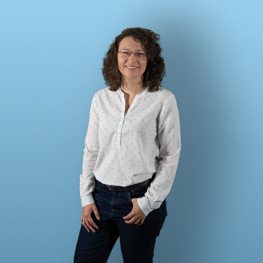 Ramona Bosse stehend vor einem blauen Hintergrund