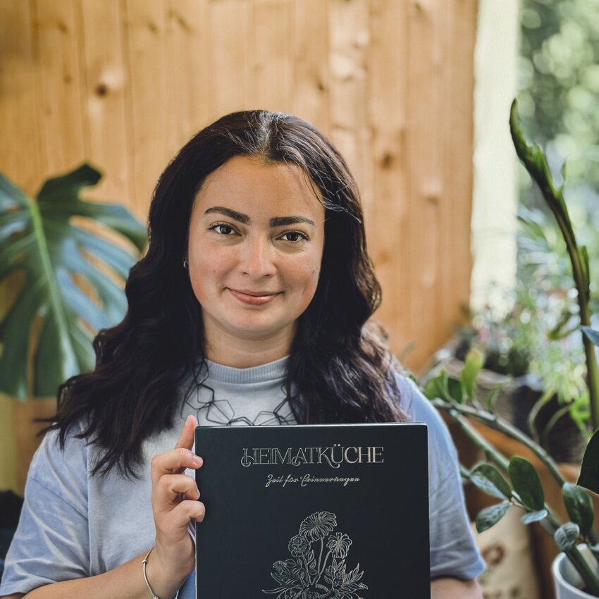 Clara Baur holds her cookbook in her hands.